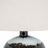 Close-up of the Hill Interiors Squat Glass Table Lamp showing the black glass base with subtle sheen and wide natural linen shade above.