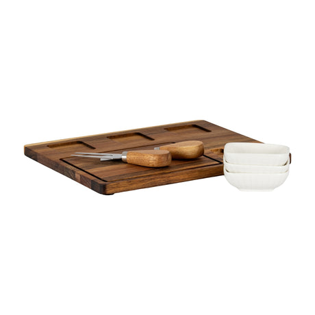 Hill Interiors acacia wood cheese board with recessed sections, wooden-handled knife and fork, and three stacked white ceramic bowls on a white background.