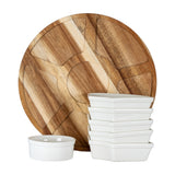Hill Interiors acacia lazy Susan with round wooden base and stacked white ceramic serving bowls on a plain background.