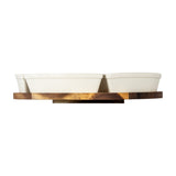 Side view of Hill Interiors acacia lazy Susan with two white ceramic serving bowls on a round brown wooden rotating base, shown on a white background.