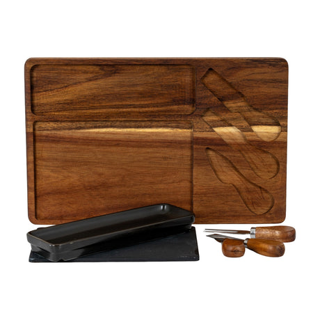 Hill Interiors acacia cheese board set in brown with recessed compartments, black rectangular bowl, slate panel and three wood-handled cheese knives.