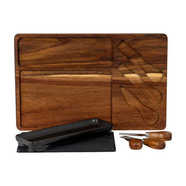 Hill Interiors acacia cheese board set in brown with recessed compartments, black rectangular bowl, slate panel and three wood-handled cheese knives.