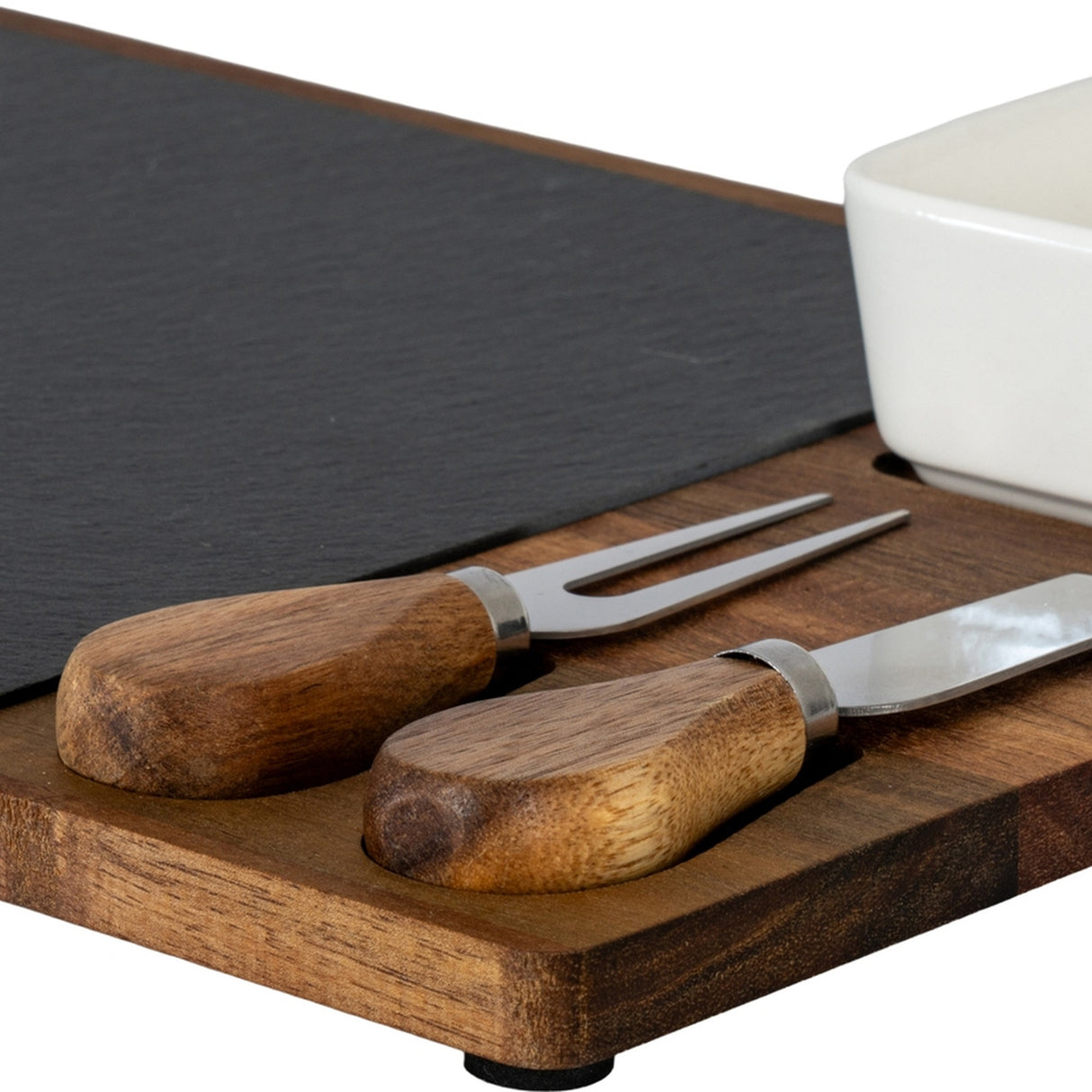 Close-up of Hill Interiors Acacia Cheese Board Set showing wooden-handled cheese knife and fork, slate insert and white ceramic bowl on brown acacia tray.
