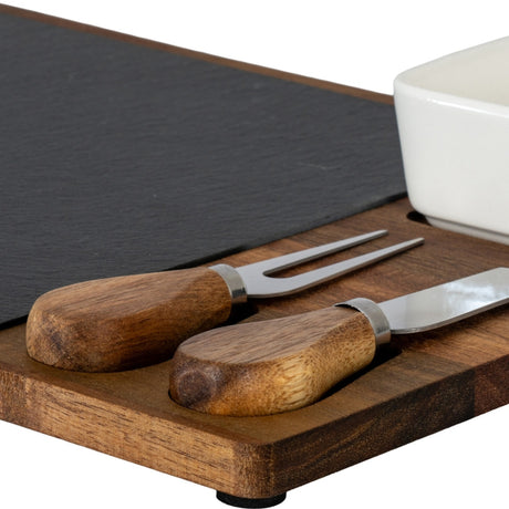 Close-up of Hill Interiors Acacia Cheese Board Set showing wooden-handled cheese knife and fork, slate insert and white ceramic bowl on brown acacia tray.