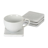 Hill Interiors Set of Four Square Marble Coasters in white with soft grey veining, shown stacked beside a white cup resting on a single coaster.