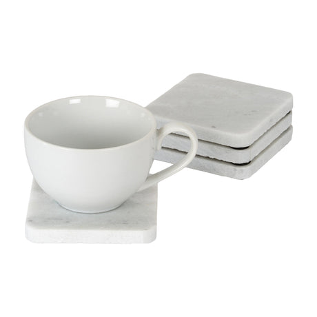 Hill Interiors Set of Four Square Marble Coasters in white with soft grey veining, shown stacked beside a white cup resting on a single coaster.