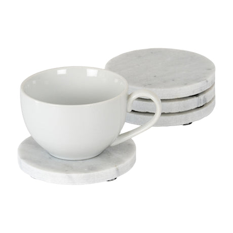 Hill Interiors set of four round white marble coasters with grey veining, three stacked beside a white ceramic cup resting on one coaster.