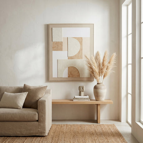 Hill Interiors Linen Textured Canvas in Wood Frame in beige, portrait abstract geometric design above a wooden bench with pampas grass in a living room.