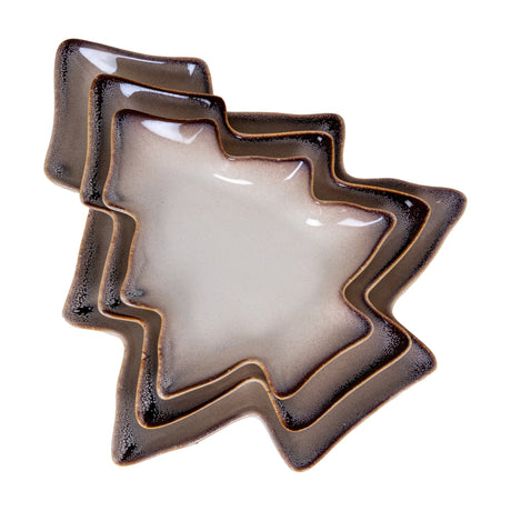 Set of three nested ceramic Christmas tree dishes by Hill Interiors with glossy glazed finish, cream centre and speckled brown edges, on a white background.