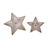 Hill Interiors small cement star candle holders in white, shown as two flat star-shaped dishes with central candle wells, on a plain white background.