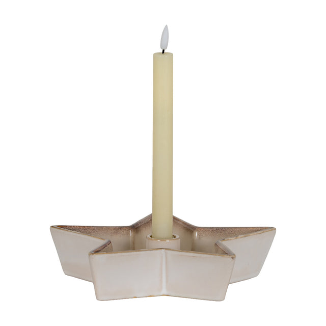 Hill Interiors large white ceramic five-pointed star candle holder with a central well holding a tall cream taper candle on a white background.
