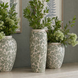 Hill Interiors Large Tall Ceramic Clover Olpe Vases in white with green floral patterning, displayed with leafy foliage on a mantel against botanical prints.