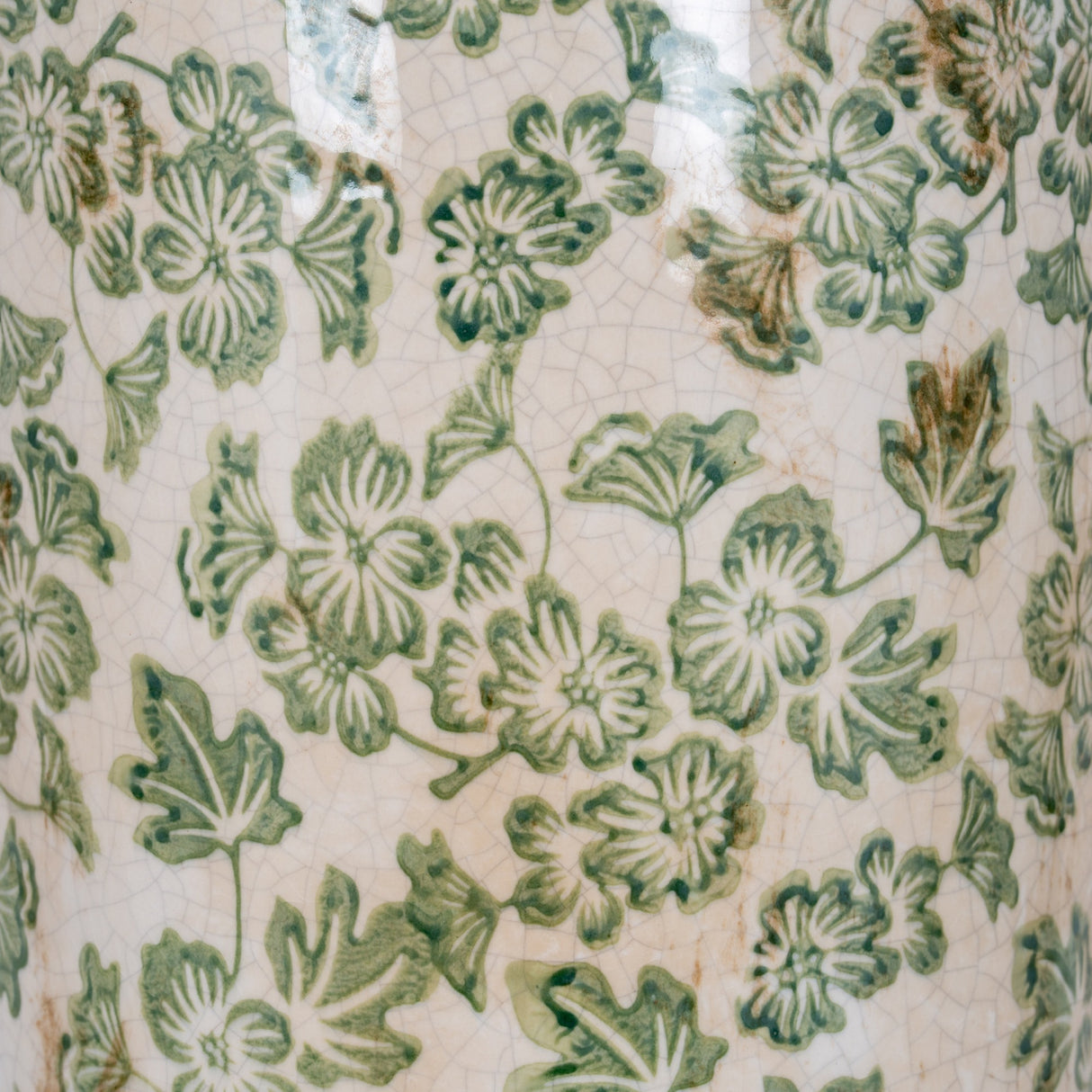 Close-up of Hill Interiors Large Tall Ceramic Clover Olpe Vase showing crackle-glaze surface with green floral and leaf pattern on a cream ground.