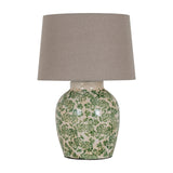 Hill Interiors Ceramic Pot Table Lamp with rounded cream base in green floral glaze, topped with a tapered natural linen shade on a white background.
