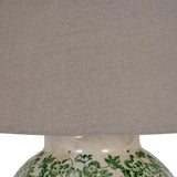 Close-up of Hill Interiors Ceramic Pot Table Lamp with green floral crackle-glaze base and natural linen drum shade.
