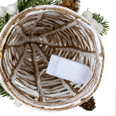 Top-down view into the open base of Hill Interiors' white rattan LED cone tree, showing woven strands, jute cord and a battery pack.