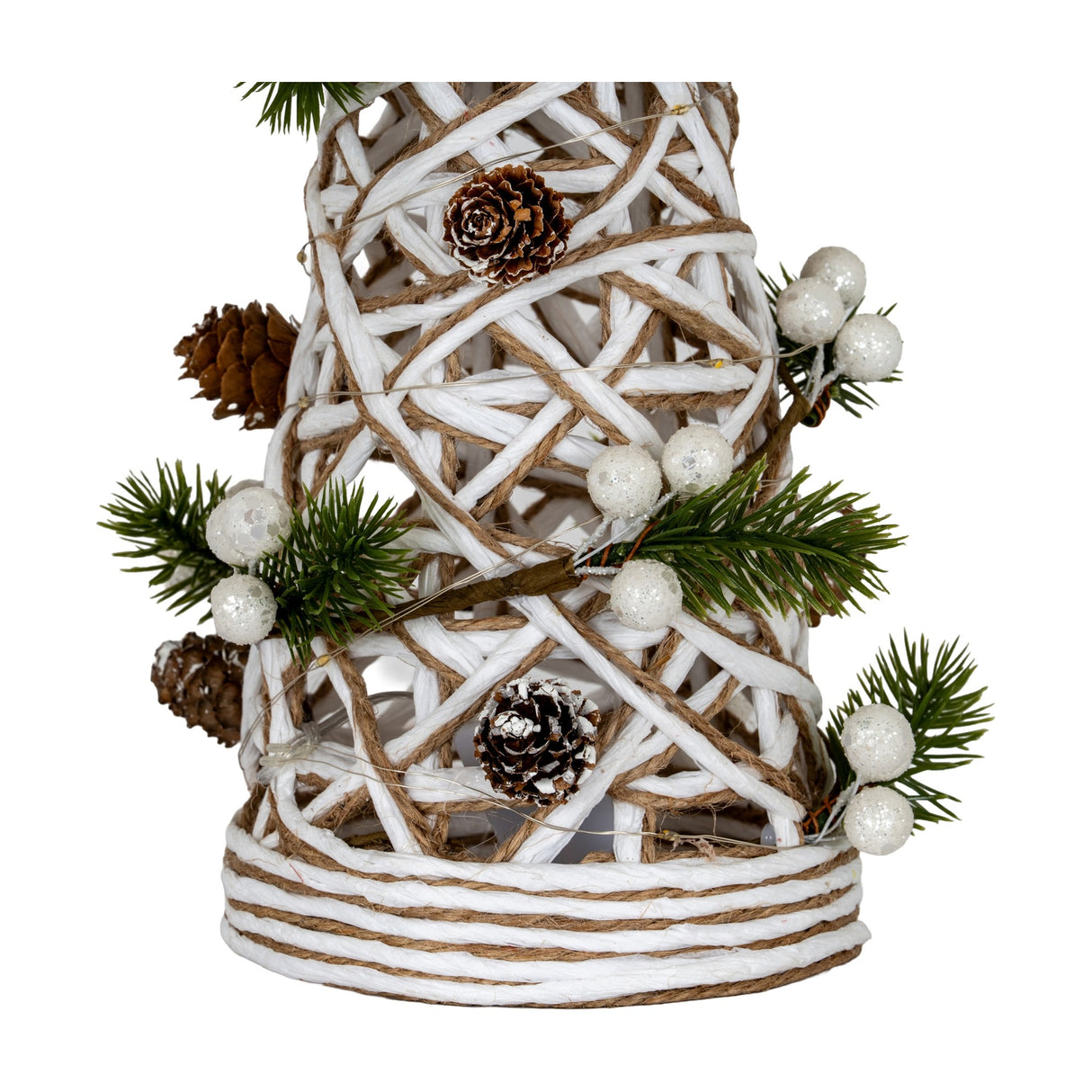 Close-up of the Hill Interiors Large LED White Rattan Cone Tree base, showing woven white and jute strands with pinecones, frosted berries and pine sprigs.