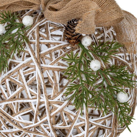 Close-up of Hill Interiors Large LED White Rattan-Effect Bauble showing woven plastic strands, hessian ribbon, pinecone, greenery sprigs and white berries.