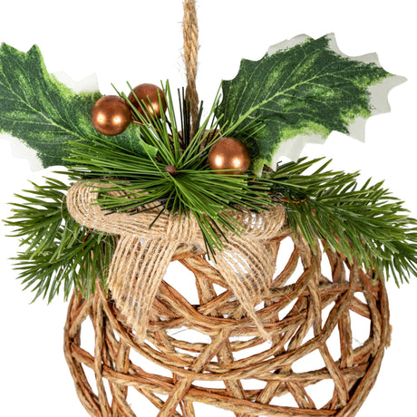 Hill Interiors Natural Rattan Bell Decoration in beige with woven strands, jute ribbon, pine sprigs, holly leaves and copper berries on a hanging cord.