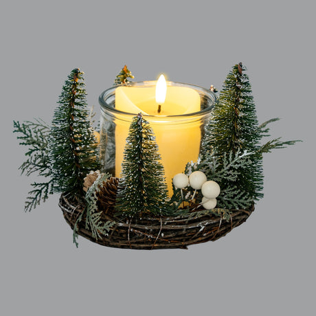 Hill Interiors Medium Brush Tree Candle Wreath in green with pinecones and white berries, framing a lit pillar candle in a glass holder.