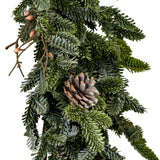 Close-up of Hill Interiors Woodland Pine Garland showing deep green moulded plastic pine sprigs, a small pinecone and slim twigs against a white background.