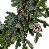 Close-up of Hill Interiors Woodland Pine Wreath in green, showing faux plastic pine needles, small cones and pink berry buds on twig stems.