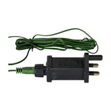 UK plug adaptor with coiled green cable for the Hill Interiors pre-lit LED fir tree, shown on a plain white background.