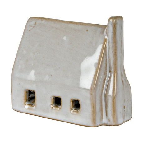 Hill Interiors Ceramic Barn with LED Light in white glaze, showing pitched roof, tall chimney and three small square window openings, on a plain background.