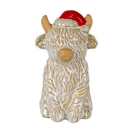 Hill Interiors ceramic Highland cow ornament in white glazed finish with shaggy textured coat and red Santa hat, shown on a plain white background.