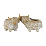 Two Hill Interiors ceramic Highland cow planters with shaggy textured coats, white glaze and tan horns and muzzles, shown on a plain white background.
