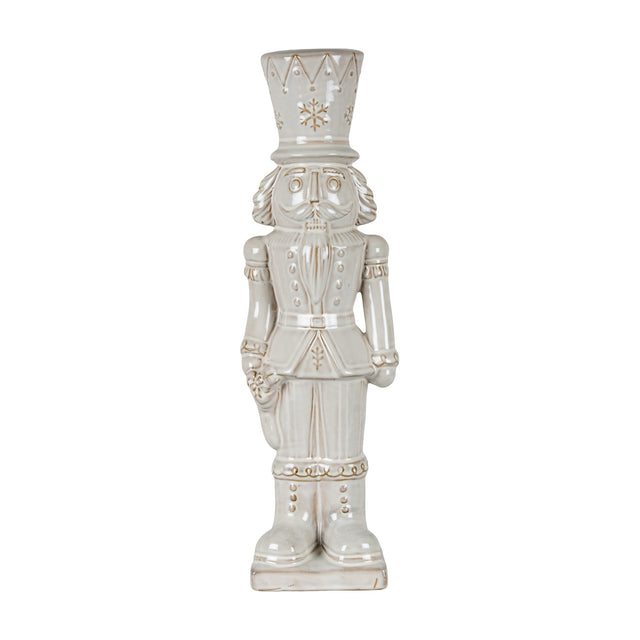 Hill Interiors Ceramic Nutcracker With Stocking in white, a tall glazed figure with crown hat, moustache and soldier uniform, on a plain background.