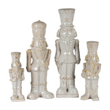 Hill Interiors Ceramic Nutcracker with Drum in white glaze, shown in a set of four soldier figures with tall hats and moustaches in varying heights.