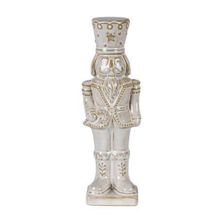 Hill Interiors Ceramic Nutcracker with Candy Cane in white with soft gold detailing, shown against a plain white background.