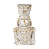 Hill Interiors Ceramic Nutcracker figure in white with gold-toned detailing, star motif on hat and moustached soldier styling, shown on a plain background.