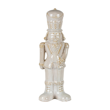 Hill Interiors ceramic nutcracker in a white glazed finish, holding a candy lollipop, with moulded moustache, tall hat and military uniform detailing.