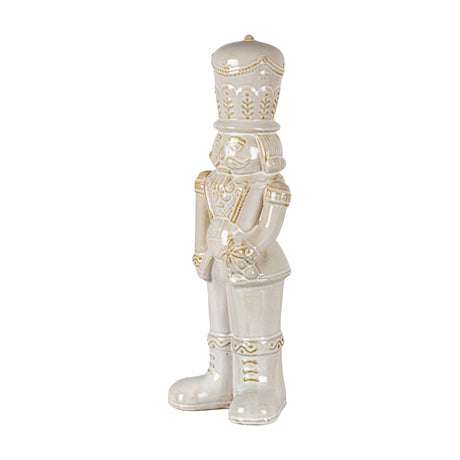 Hill Interiors Ceramic Nutcracker soldier in white glaze with moulded hat, moustache and boots, holding a candy lollipop, shown on a plain background.