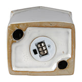 Underside view of the Hill Interiors ceramic townhouse LED light in white, showing the battery compartment and on/off switch on a plain background.