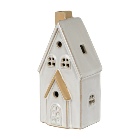 Hill Interiors ceramic medium townhouse LED light in white glaze, with pitched roof, chimney, arched door and cut-out windows, on a plain background.