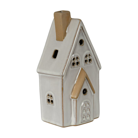 Hill Interiors ceramic medium townhouse LED light in white glaze with pitched roof, chimney, arched windows and door on a plain background.