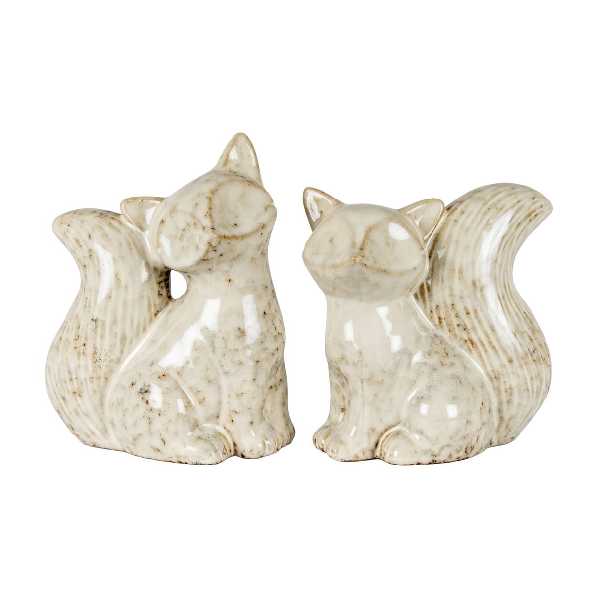 Pair of Hill Interiors ceramic fox ornaments in a speckled cream glaze, shown seated with bushy tails on a plain white background.