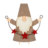 Hill Interiors Cheeky Metal Elf figure in brown with white beard, pointed hat and raised arms holding a red star garland, on a white background.