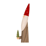 Hill Interiors wooden festive elf figure in brown with a red white-spotted pointed hat, long white beard, holding a small green tree, on a white background.