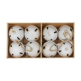 Hill Interiors set of eight large white metal Christmas bells with black star cut-outs and jute loops, arranged in a divided wooden box.
