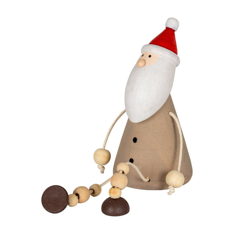 Hill Interiors wooden sitting Santa decoration with red hat, white beard and brown body with dangling beaded legs, shown on a plain white background.