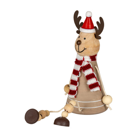 Hill Interiors wooden sitting reindeer decoration with antlers, red Santa hat, red and white striped scarf and dangling beaded legs, on a white background.