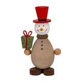 Hill Interiors Wooden Snowman with Present in brown, with a red top hat, green plaid scarf and green polka-dot gift, on a white background.