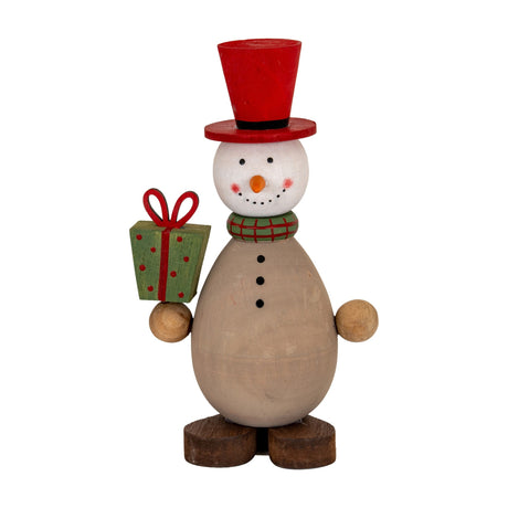 Hill Interiors Wooden Snowman with Present in brown, with a red top hat, green plaid scarf and green polka-dot gift, on a white background.