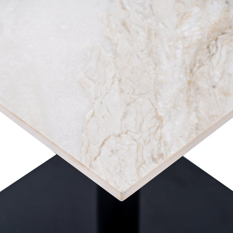 Corner detail of the Hill Interiors Stanwyke square dining table with beige stone-effect top, natural veining, and matte black metal base.