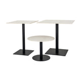 Hill Interiors Stanwyke square stone-effect dining tables in beige with black metal pedestal bases, shown alongside a smaller round table on a white background.