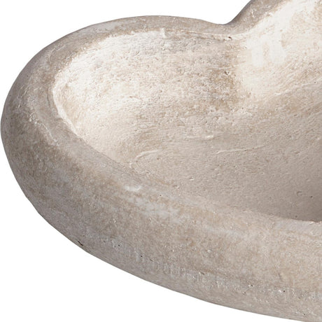 Close-up of the Hill Interiors Deep Stone Heart Dish in beige, showing the smooth matte stone surface and shallow curved interior of the heart-shaped bowl.